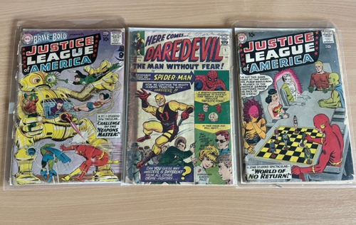 Daredevil #1, centre, and two early DC Justice League comics, going to auction on December 1.