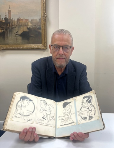 Ephemera valuer Robert French with the album.