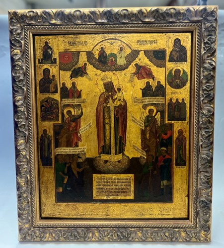 A large icon heavily gilded of the Virgin Mary with saintly attendants.