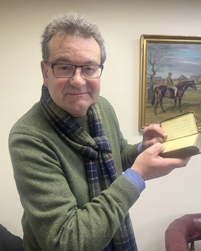 Auctioneer Richard Winterton with the prayer book.