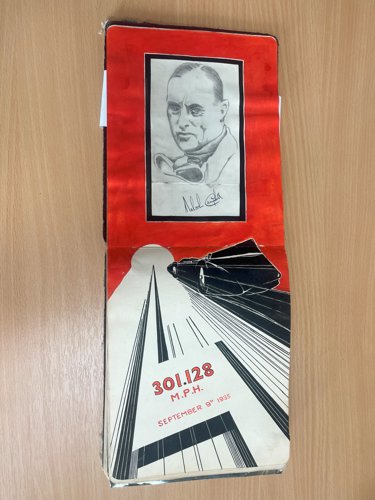 Striking artwork surrounds a signed drawing of land speed record driver Sir Malcolm Campbell.