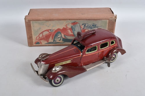 This 1930s Kosuge tinplate clockwork police car with siren made £1,250 at auction.