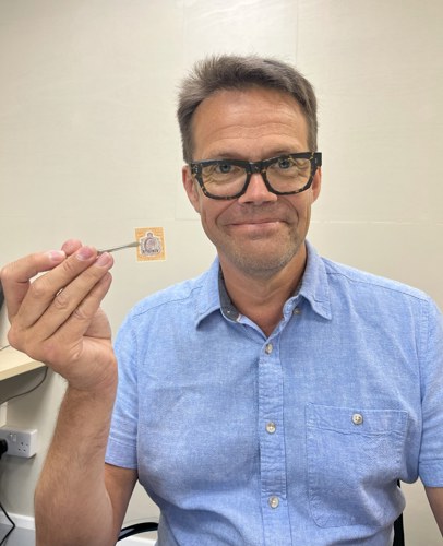 Richard Winterton Auctioneers’ stamp expert Phil Ives with the $500 Straits Settlements overprinted specimen.