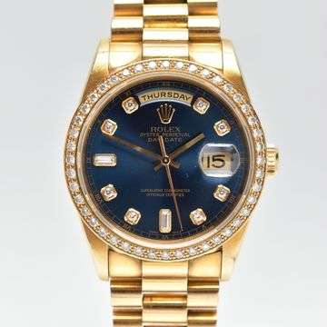 This 18ct gold and diamond Rolex Day-Date realised £13,400.