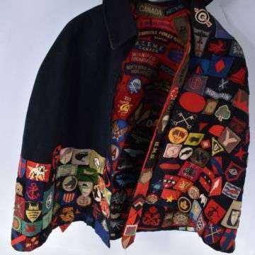 Adorned with military badges gifted by hundreds of wounded personnel, the nurse’s cape sold at auction for £10,000.