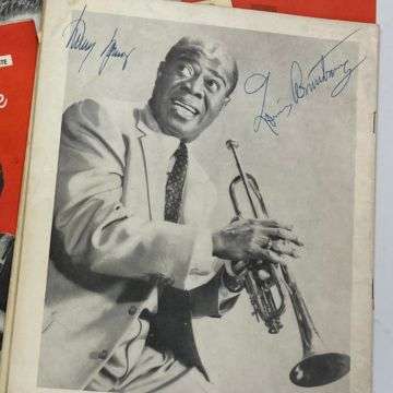 The 1956 programme is signed on the back cover by legendary trumpeter and vocalist Louis Armstrong.
