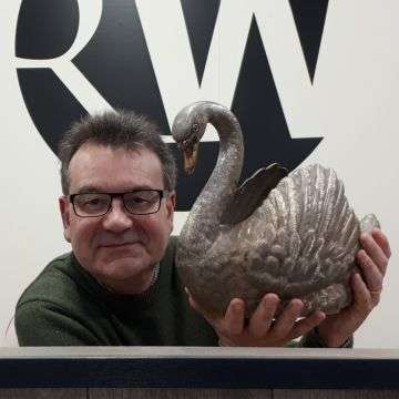 Auctioneer Richard Winterton with the silver swan.