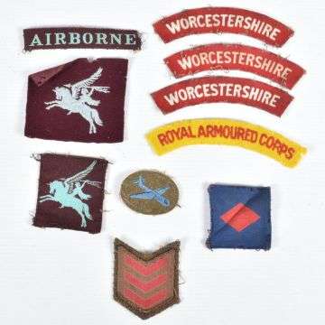 These WW2 and later cloth insignia sold at £440.