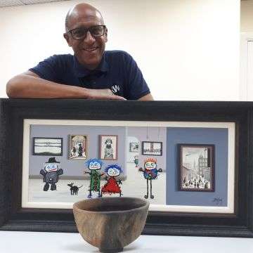 Decorative arts valuer David Fergus with a Martin McWilliam illusion bowl and a John D Wilson picture.